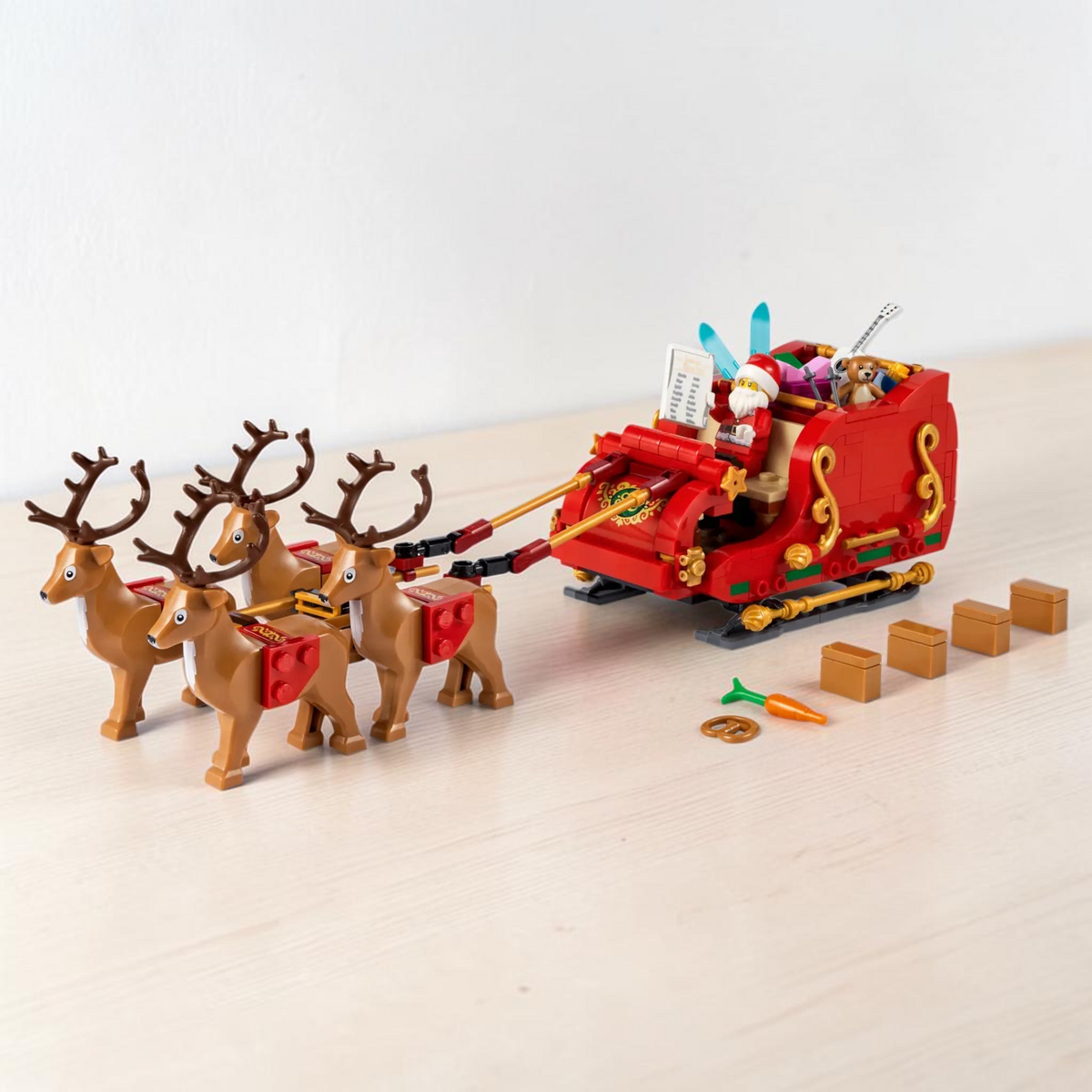 [lifestyle-shelf-built] A Brick Apart LEGO Santa's Sleigh set featuring a red sleigh, Santa minifigure, four reindeer, and assorted gifts.