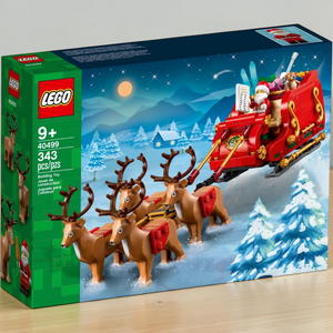 [lifestyle-shelf-box] A Brick Apart LEGO Santa's Sleigh set box featuring a red sleigh, four reindeer, and a Santa minifigure in snow.