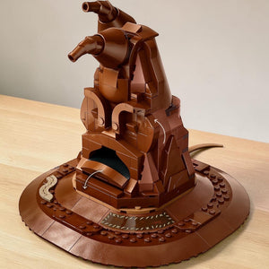 [lifestyle-shelf-built] A Brick Apart LEGO Harry Potter Talking Sorting Hat buildable model with brown bricks and interactive sound features.