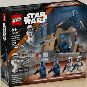 [lifestyle-shelf-box] A Brick Apart LEGO Star Wars Ambush on Mandalore set box featuring four minifigures, rock cave, and stud cannon.