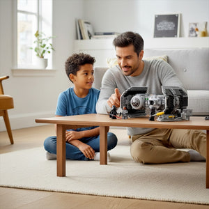 [lifestyle-person] A Brick Apart LEGO Star Wars TIE Bomber set being played with by a father and son in a bright living room.