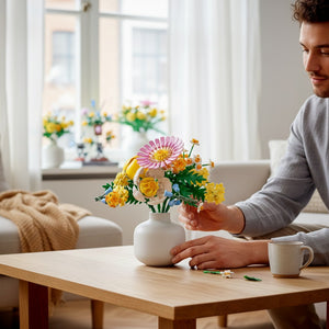 A Brick Apart LEGO Botanicals Petite Sunny Bouquet featuring pastel spring flowers in a white vase on a wooden table.
