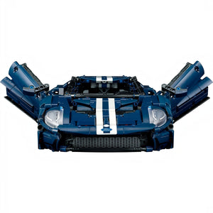 A Brick Apart LEGO Technic 2022 Ford GT model in dark blue with white racing stripes and open butterfly doors