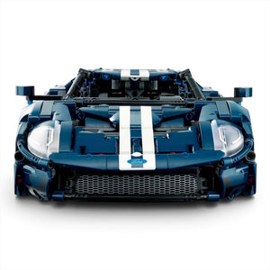 [built-angle] A Brick Apart LEGO Technic 2022 Ford GT model in dark blue with white racing stripes, viewed from the front.