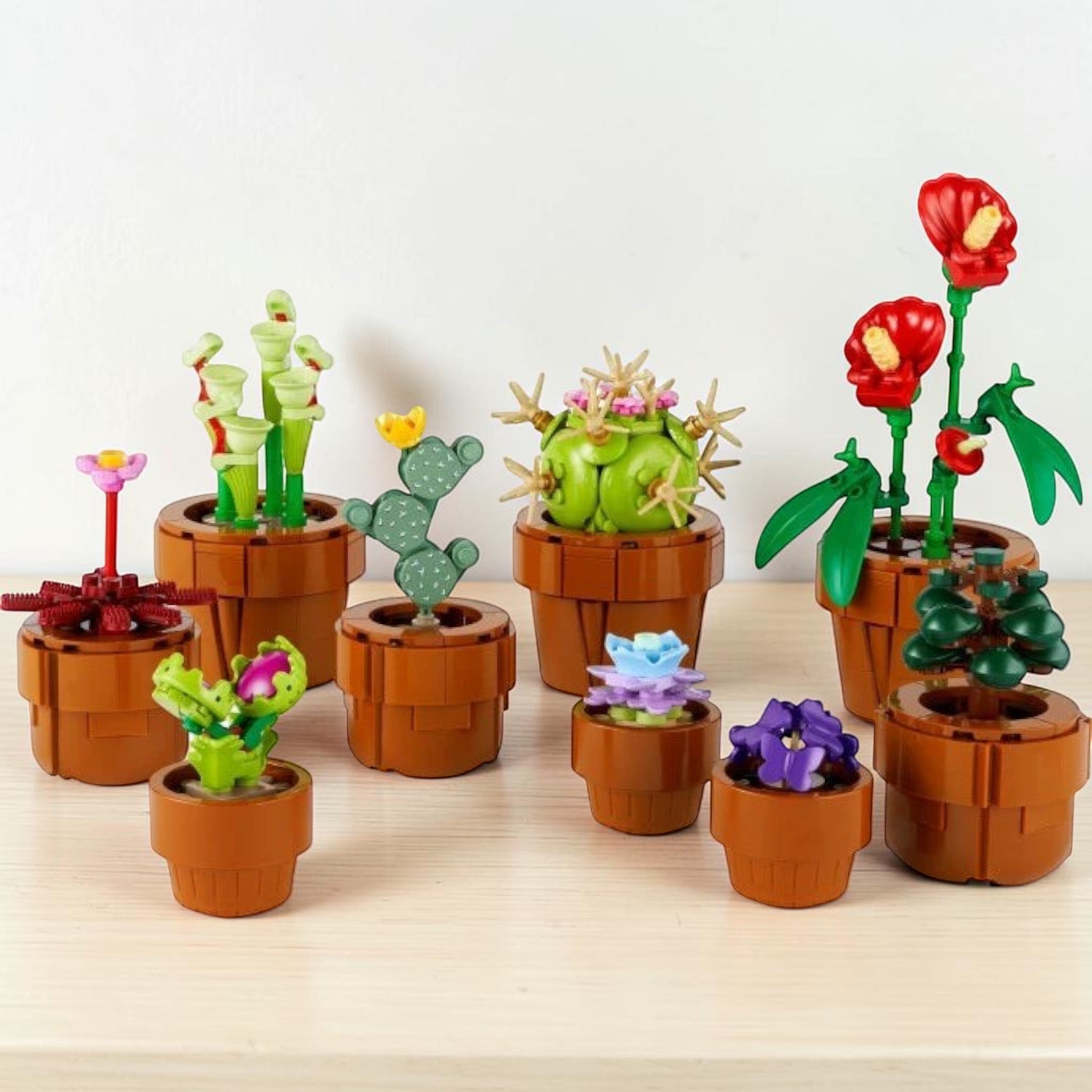 A Brick Apart LEGO Icons Tiny Plants set featuring nine colorful buildable botanical plants in terracotta-colored pots.