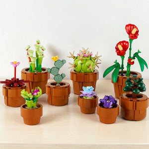 A Brick Apart LEGO Icons Tiny Plants set featuring nine colorful buildable botanical plants in terracotta-colored pots.