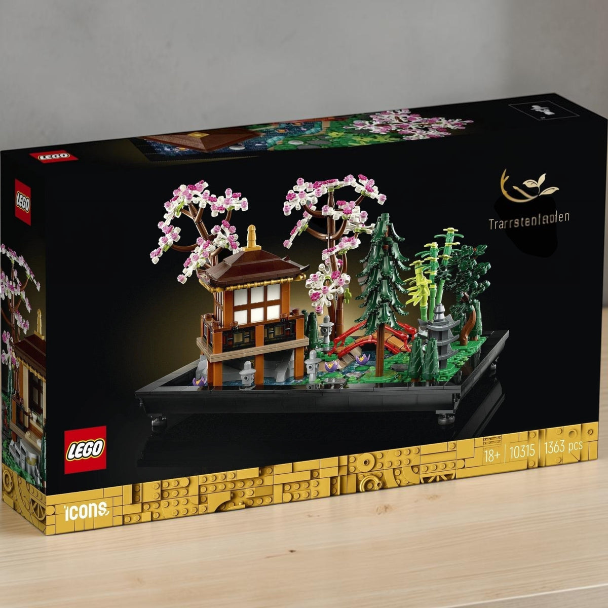 [lifestyle-shelf-box] A Brick Apart LEGO Icons Tranquil Garden set featuring a Japanese pavilion, arched bridge, and cherry blossom trees.