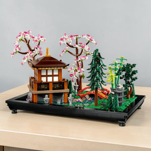 [lifestyle-shelf-built] A Brick Apart LEGO Icons Tranquil Garden set featuring a Japanese pavilion, cherry blossom trees, and arched bridge.