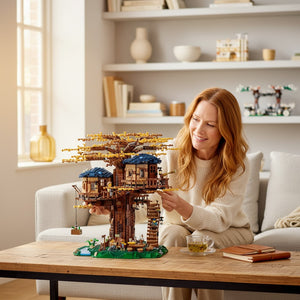 [lifestyle-person] A Brick Apart LEGO Ideas Tree House set with autumn leaves being assembled by a woman in a bright living room