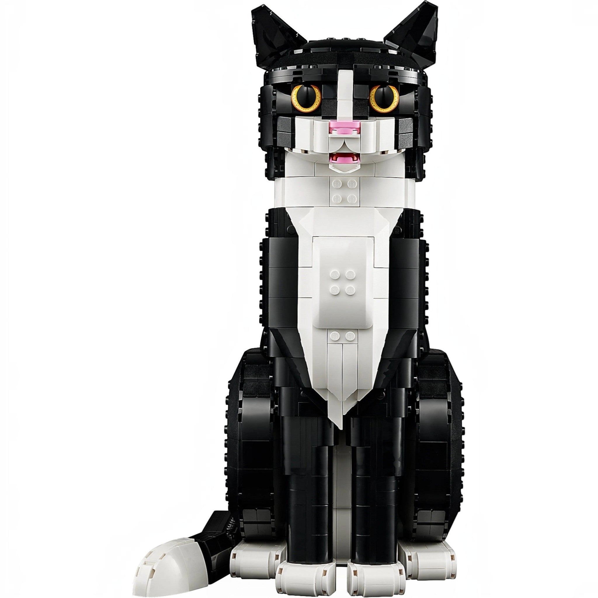 A Brick Apart LEGO Ideas Tuxedo Cat model with black and white bricks, yellow eyes, and an open mouth in a sitting pose.