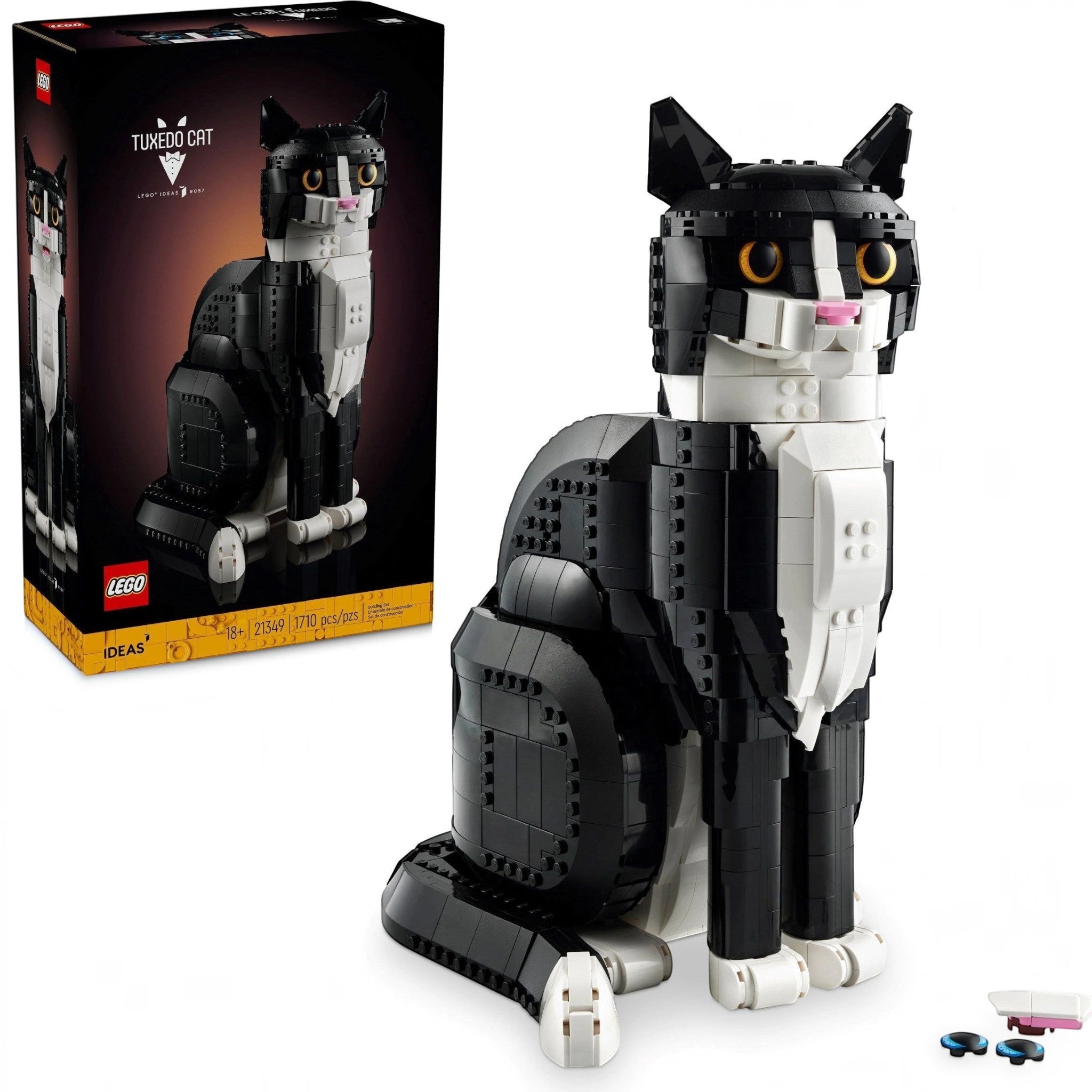 A Brick Apart LEGO Ideas Tuxedo Cat model with black and white bricks, yellow eyes, and adjustable poseable features.