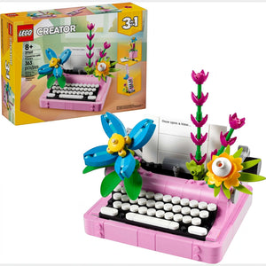 A Brick Apart LEGO Creator 3in1 typewriter set in pink with colorful brick-built flowers and a paper insert.