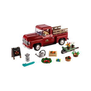 A Brick Apart LEGO 1950s vintage red pickup truck model with seasonal accessories including flowers and vegetables.