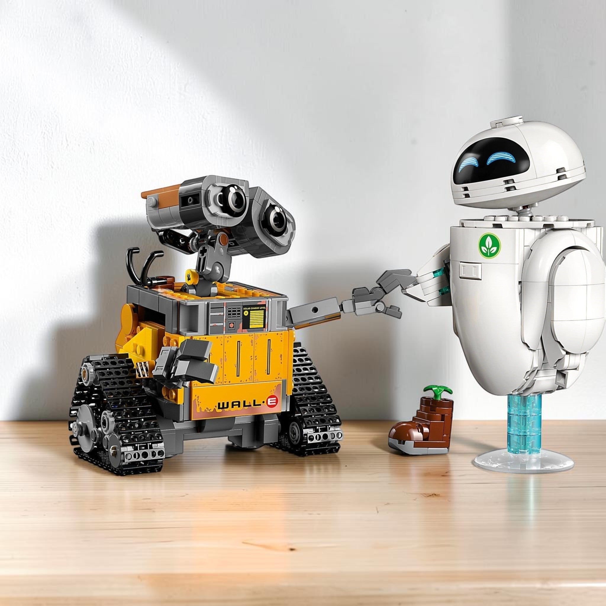 A Brick Apart LEGO Disney WALL-E and EVE building set featuring WALL-E, EVE, M-O, and a plant in a boot.