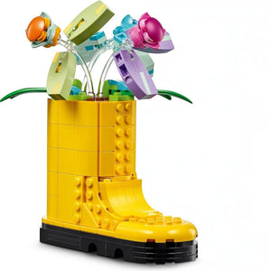 A Brick Apart LEGO Creator yellow welly boot model filled with colorful brick-built flowers and green leaves