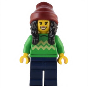 LEGO minifigure wearing a green sweater with a zigzag pattern, navy pants, and a red beanie.
