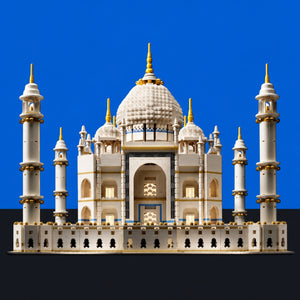 [built-blue-black] A detailed model of the Taj Mahal built from interlocking blocks, featuring a large central dome, four minarets, and arched entryways, shown against a solid blue background with a black base.