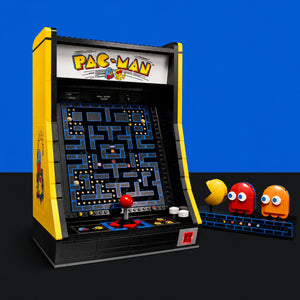 [built-blue-black] A building-block toy set of a classic Pac-Man arcade machine, shown with three ghost figures on a black surface against a blue background.