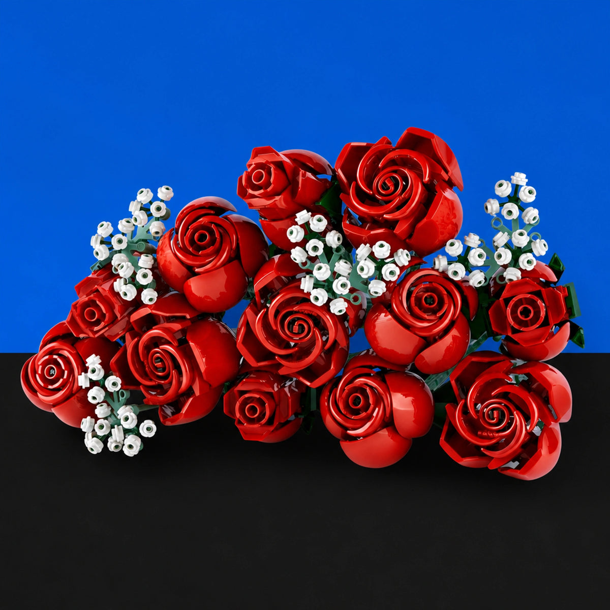 [built-blue-black] A bouquet of glossy red roses with small white filler flowers, arranged against a split blue and black background.