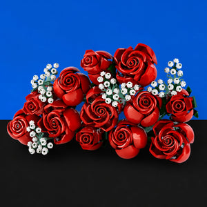 [built-blue-black] A bouquet of glossy red roses with small white filler flowers, arranged against a split blue and black background.