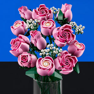 [built-blue-black] A bouquet of pink roses and small white baby's breath flowers arranged in a clear glass vase, photographed against a split blue and black studio background.