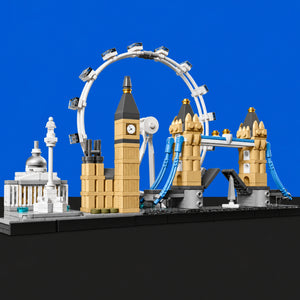[built-blue-black] A brick-built model set of London landmarks, including Big Ben, Tower Bridge, the London Eye, and the National Gallery, displayed on a black base against a solid blue background.