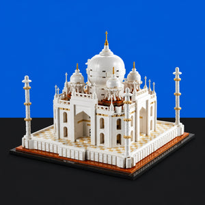 [built-blue-black] A white and gold Taj Mahal model building block structure displayed on a black base against a blue and black background.