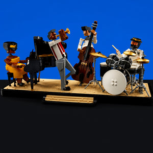 [built-blue-black] A set of small toy musicians built from interlocking blocks, arranged on a display base against a bright blue backdrop. The set includes a pianist, a trumpet player, a cello player, and a drummer, with black, white, yellow, and brown colors dominating the figures and instruments.