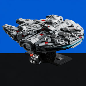 [built-blue-black] A LEGO Star Wars Millennium Falcon display model on a black stand, photographed against a split blue and black studio background.