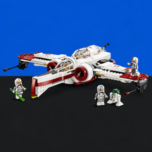 [built-blue-black] A Star Wars LEGO set featuring a white and red X-wing starfighter with four minifigures, including Stormtroopers and R2-D2, displayed on a black surface against a solid blue background.