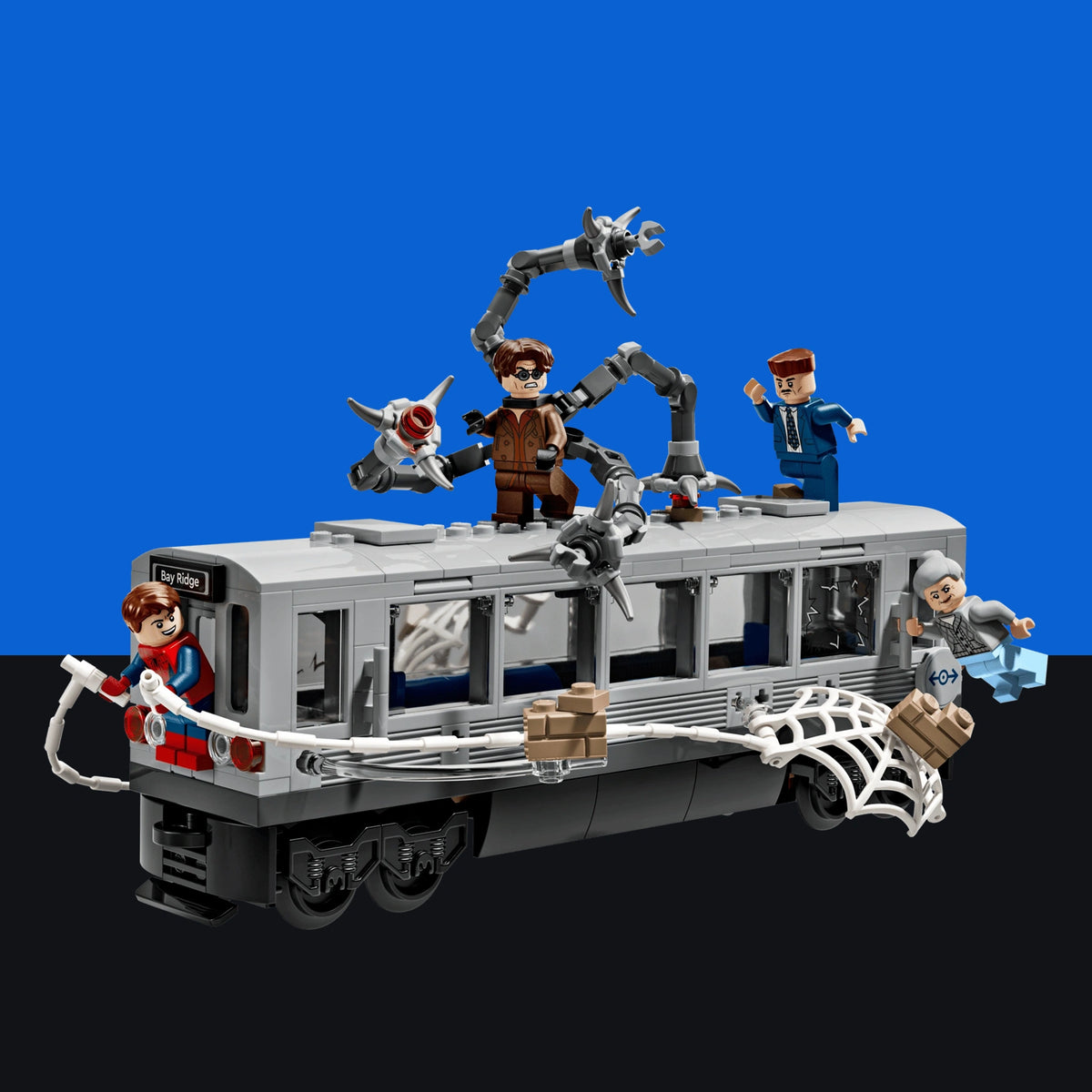 [built-blue-black] A toy building-block set featuring a gray and black tram or trolley with Spider-Man characters and accessories, including a spider on the front, webbing details, and small minifigures, shown on a blue-to-black gradient background.